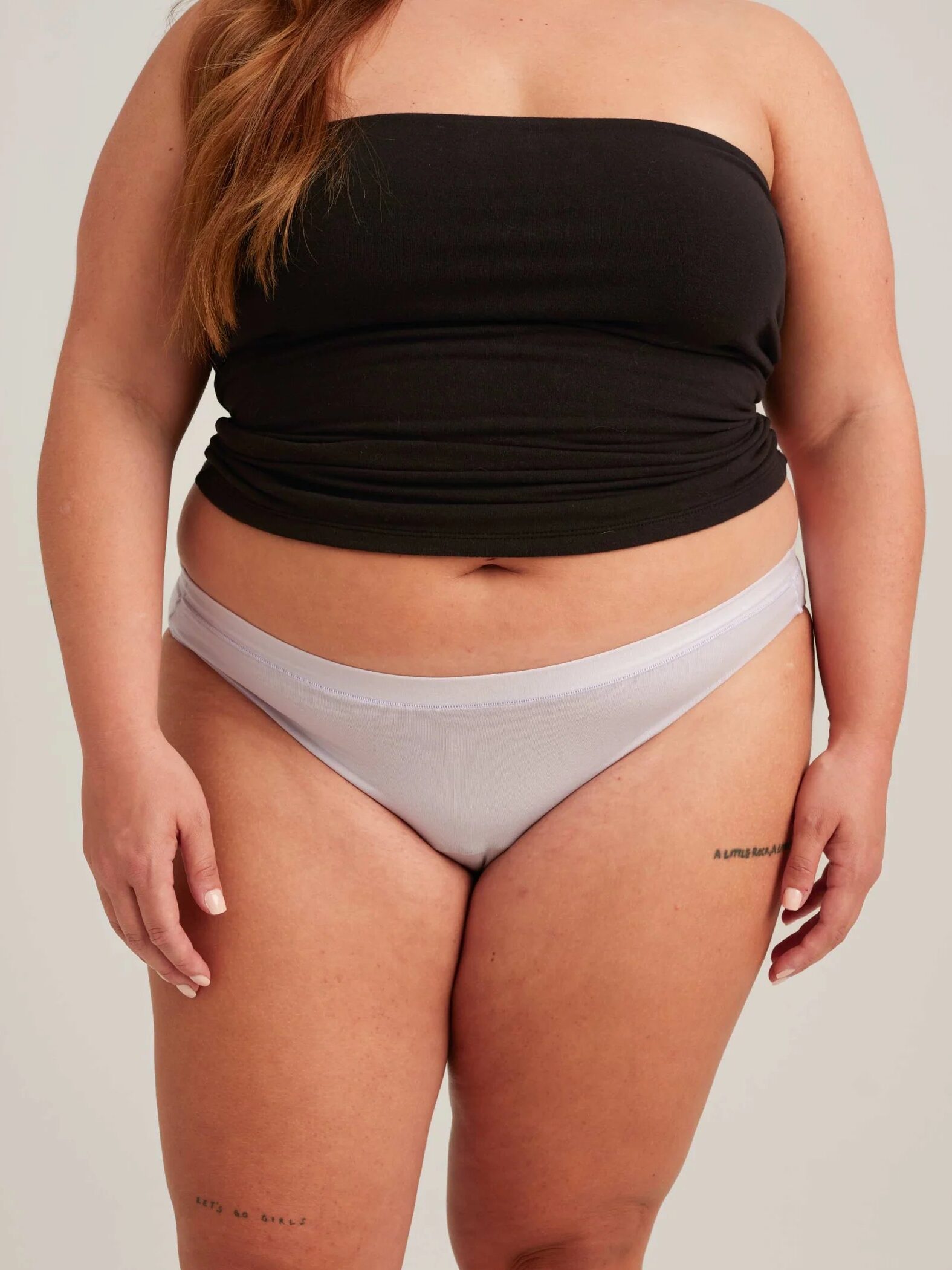 A plus size model wearing Saalt period underwear in lavender. 