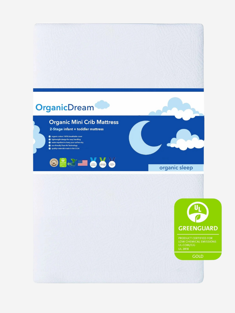 Image of an OrganicDream Mini Crib Mattress featuring certifications for organic materials and low emissions, with a blue label showing clouds and a moon.