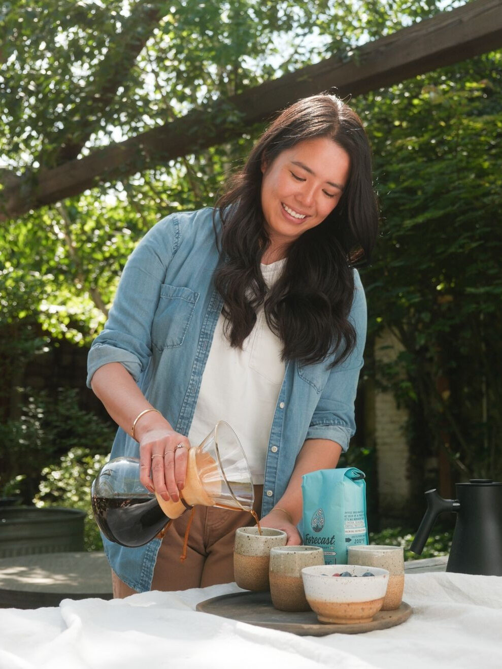 A model pouring a cup of Mistobox coffee. 