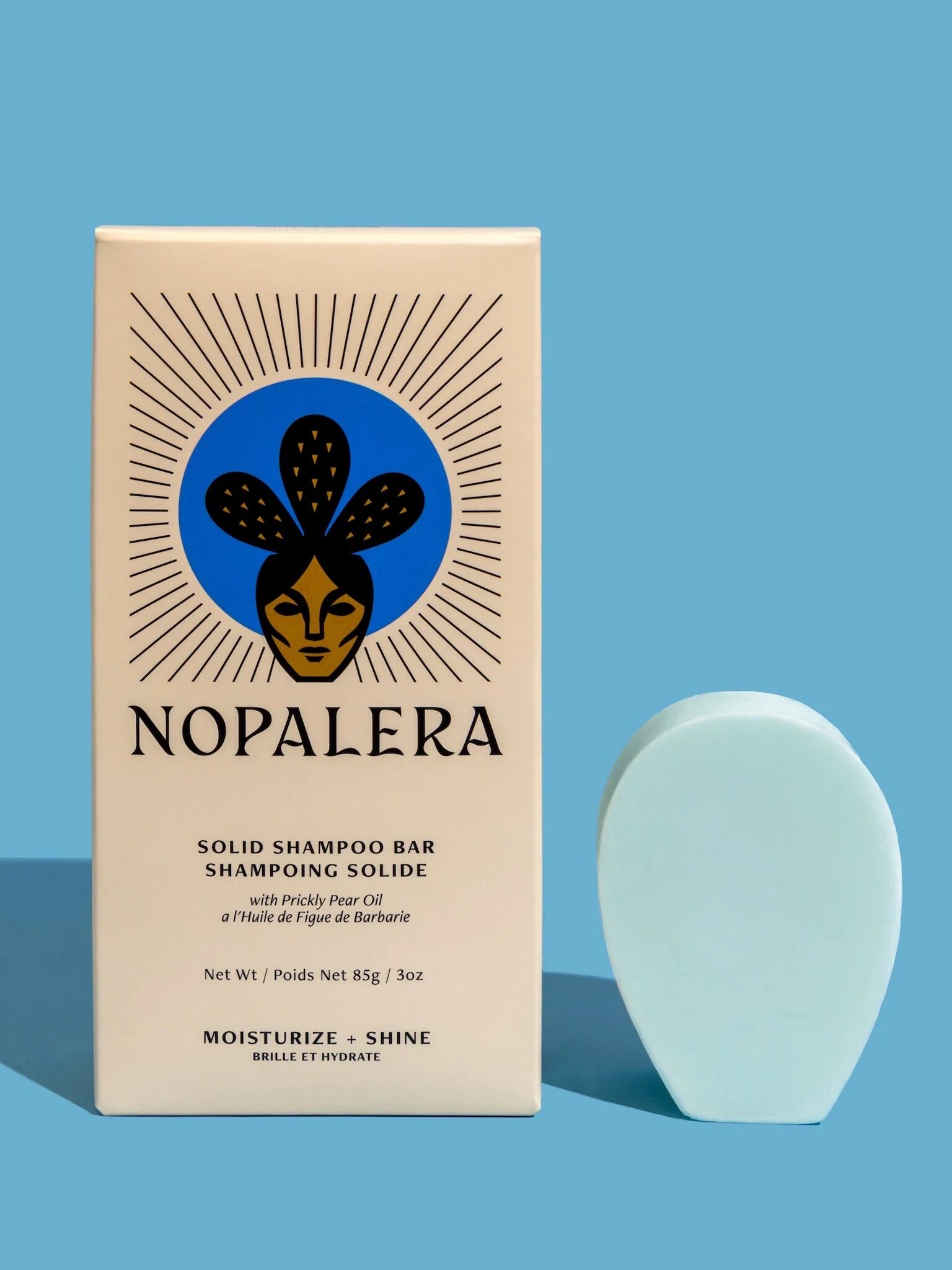 A Nopalera solid shampoo bar next to its packaging. 