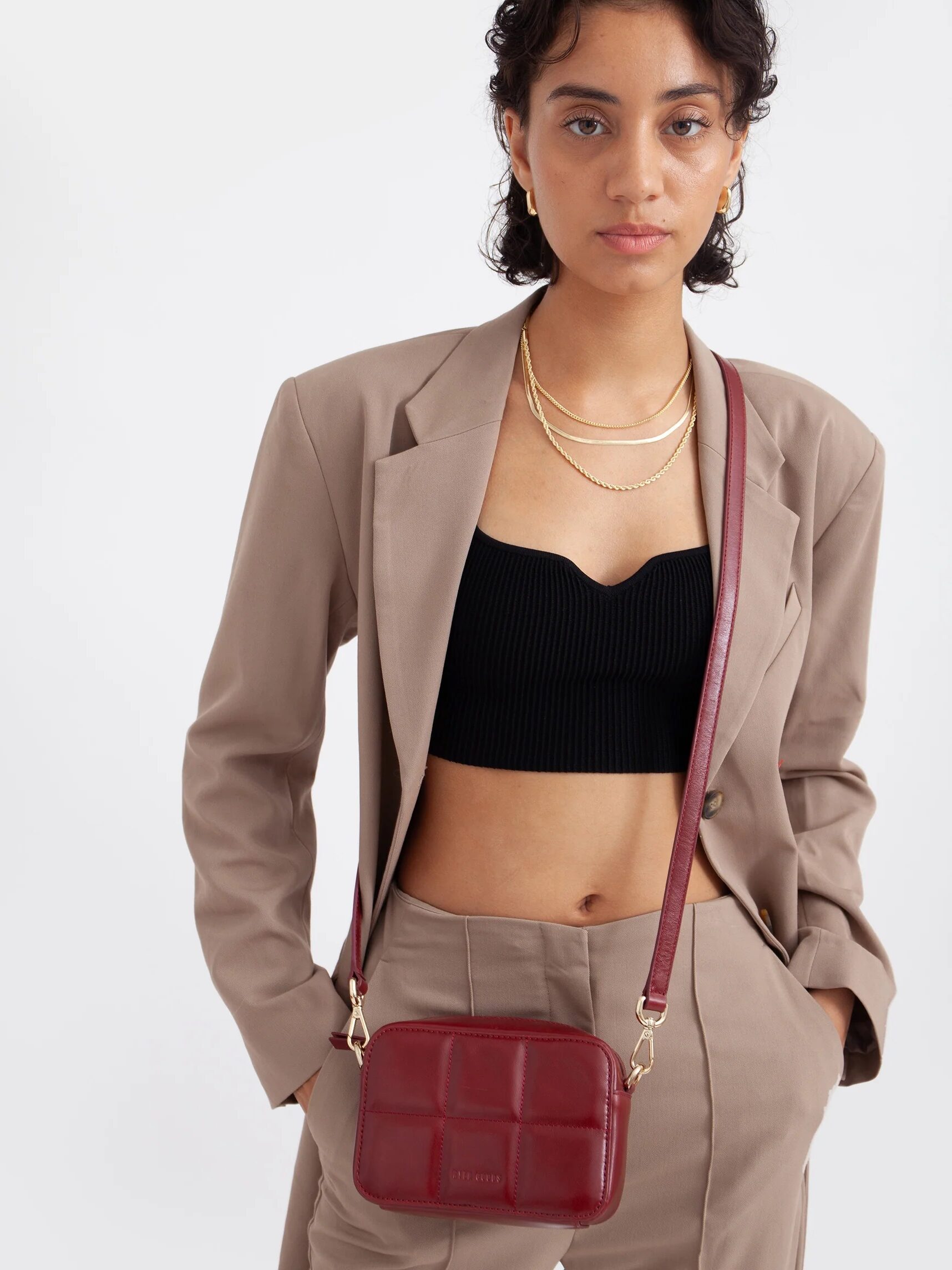 A model wearing a HYER GOODS crossbody bag.