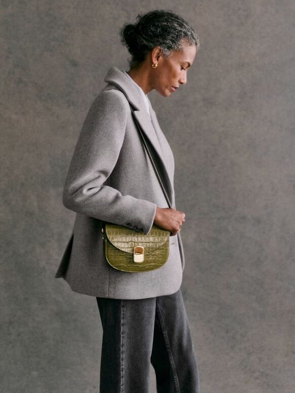 A model wearing a Sezane crossbody bag. 