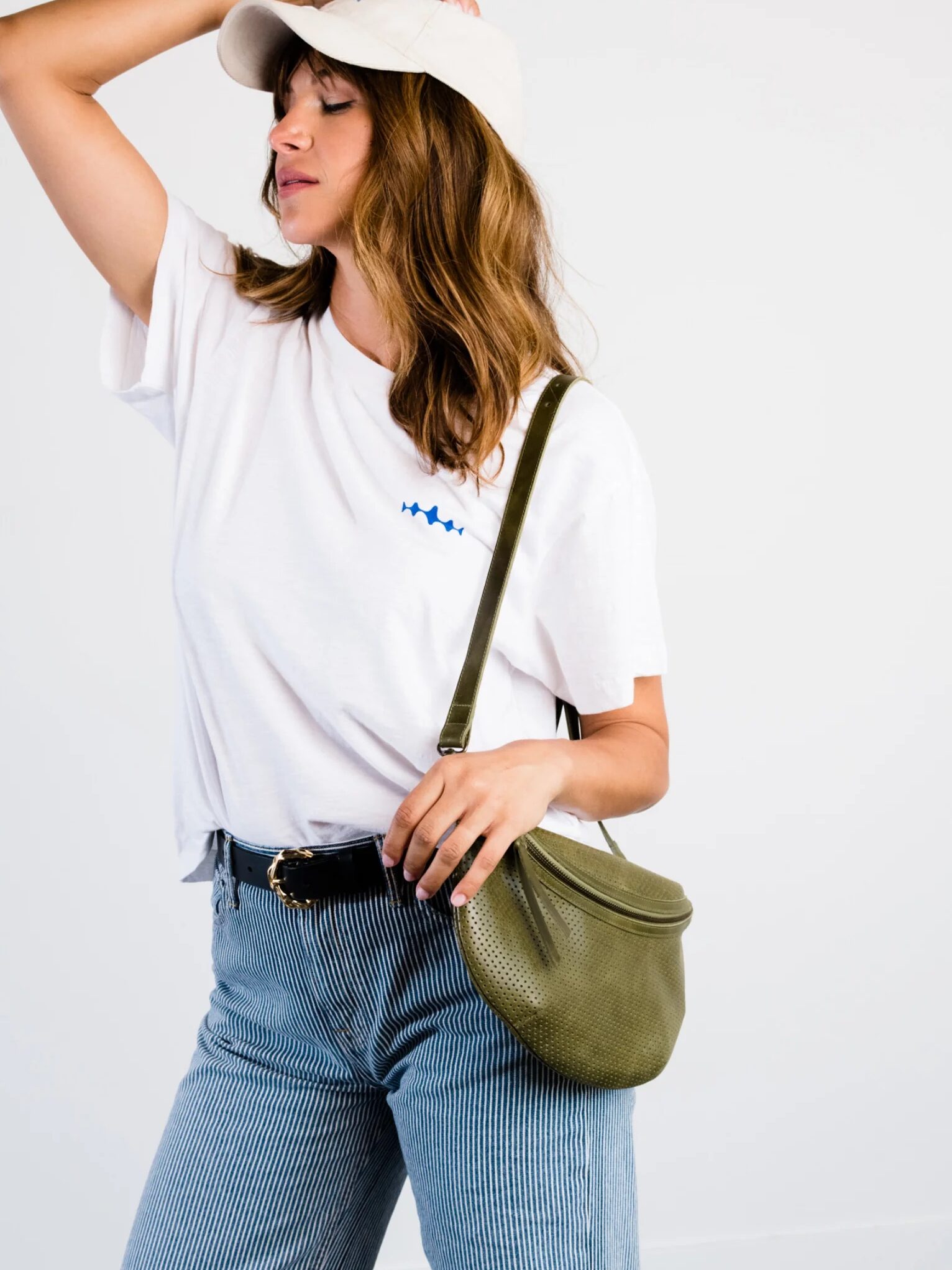 A model wearing a crossbody bag from ABLE. 