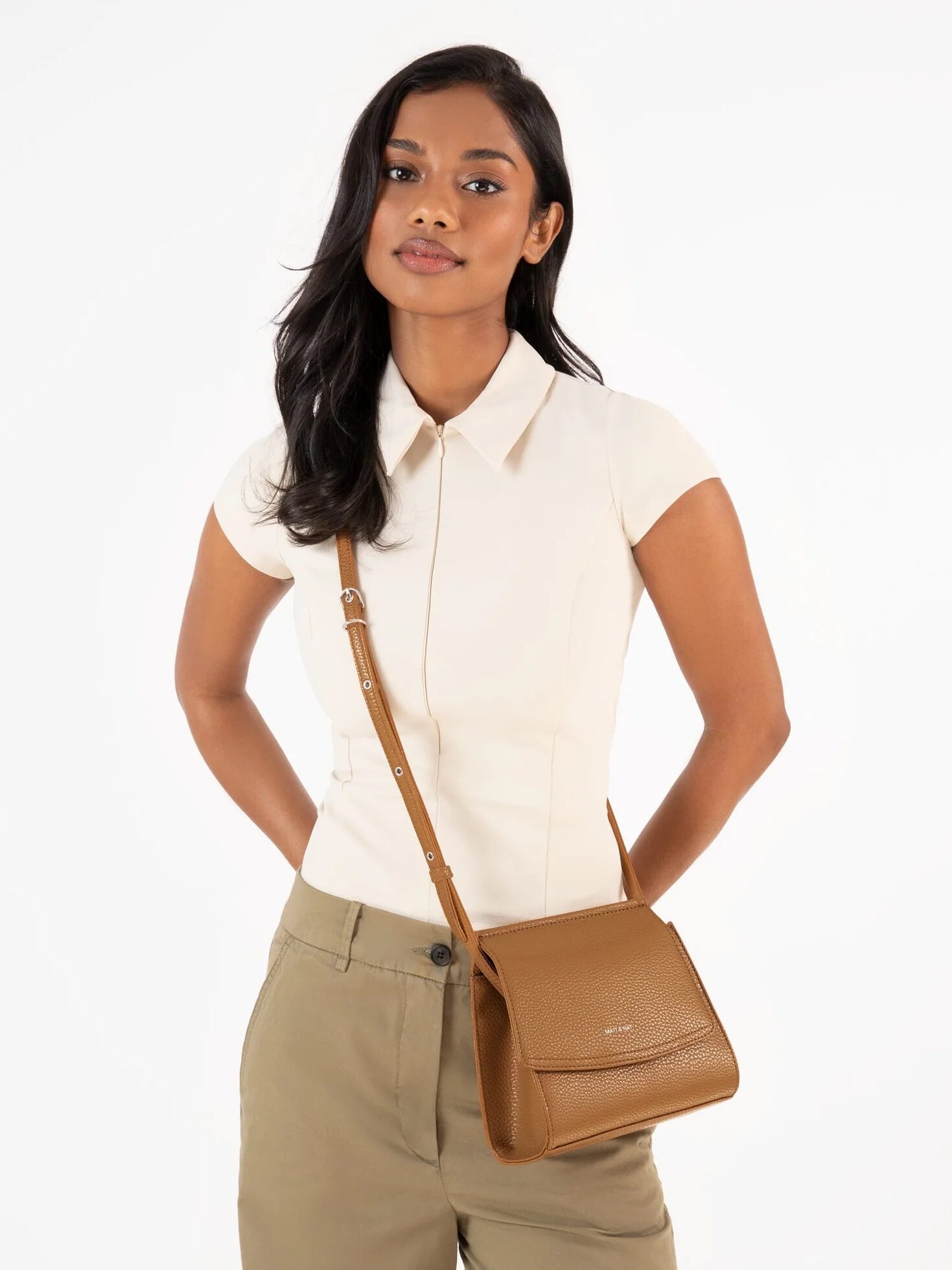 A model wearing a Matt and Nat crossbody bag. 