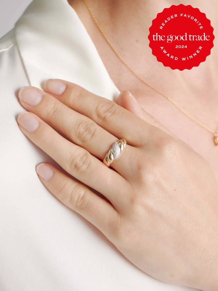 A hand wearing a gold ring with a silver accent rests on a chest. A red badge in the top right corner reads "Reader Favorite the good trade 2024 Award Winner.