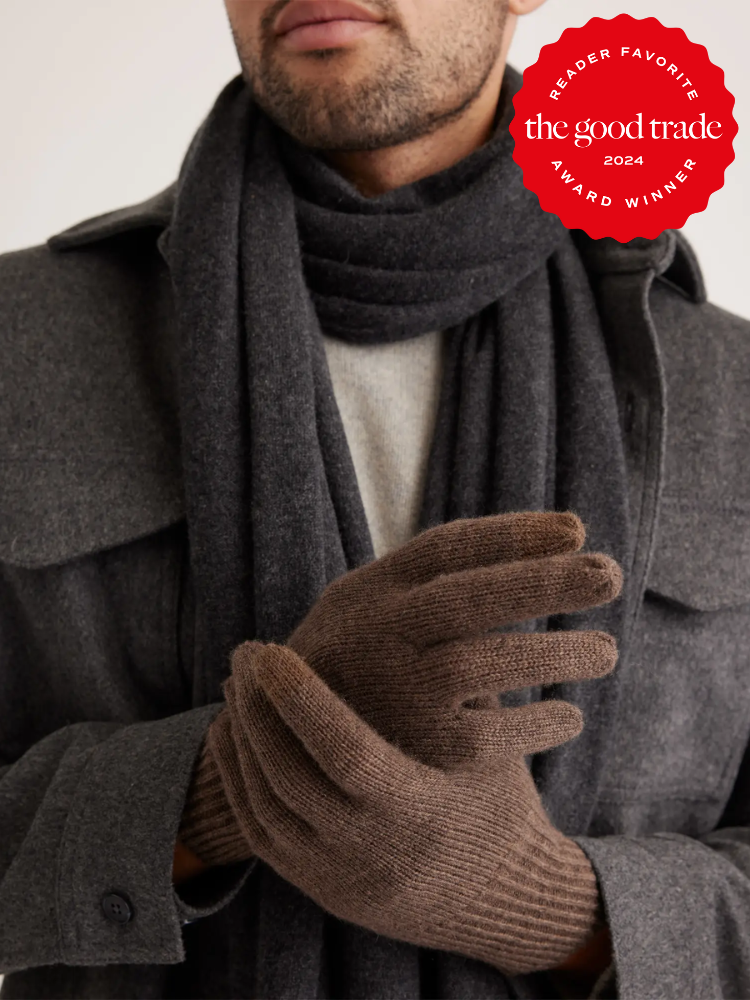 A person wearing a dark gray coat, matching scarf, and brown gloves. A red badge in the corner reads "Reader Favorite The Good Trade 2024 Award Winner.