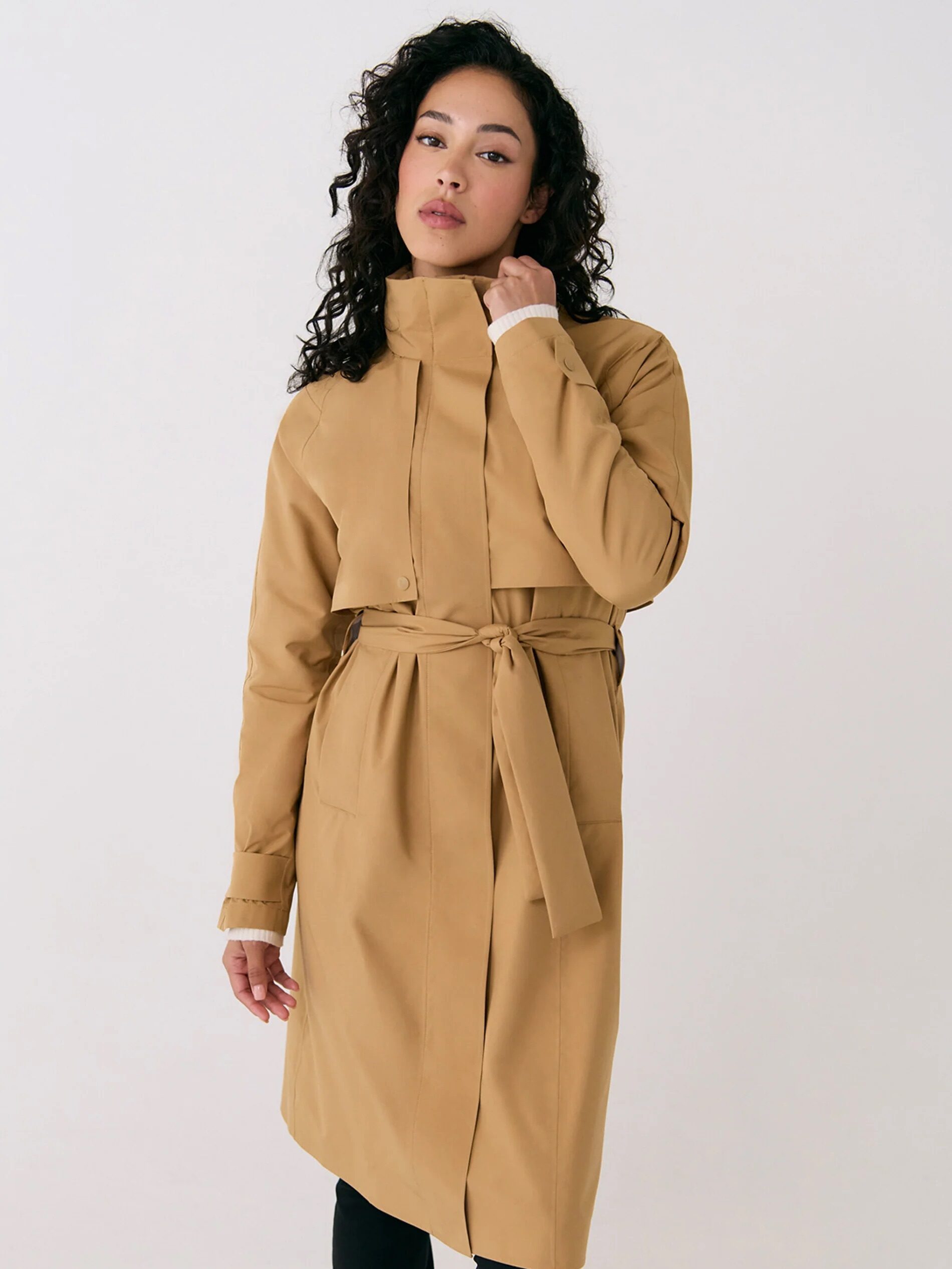 A model wearing a Lole tan trench coat. 