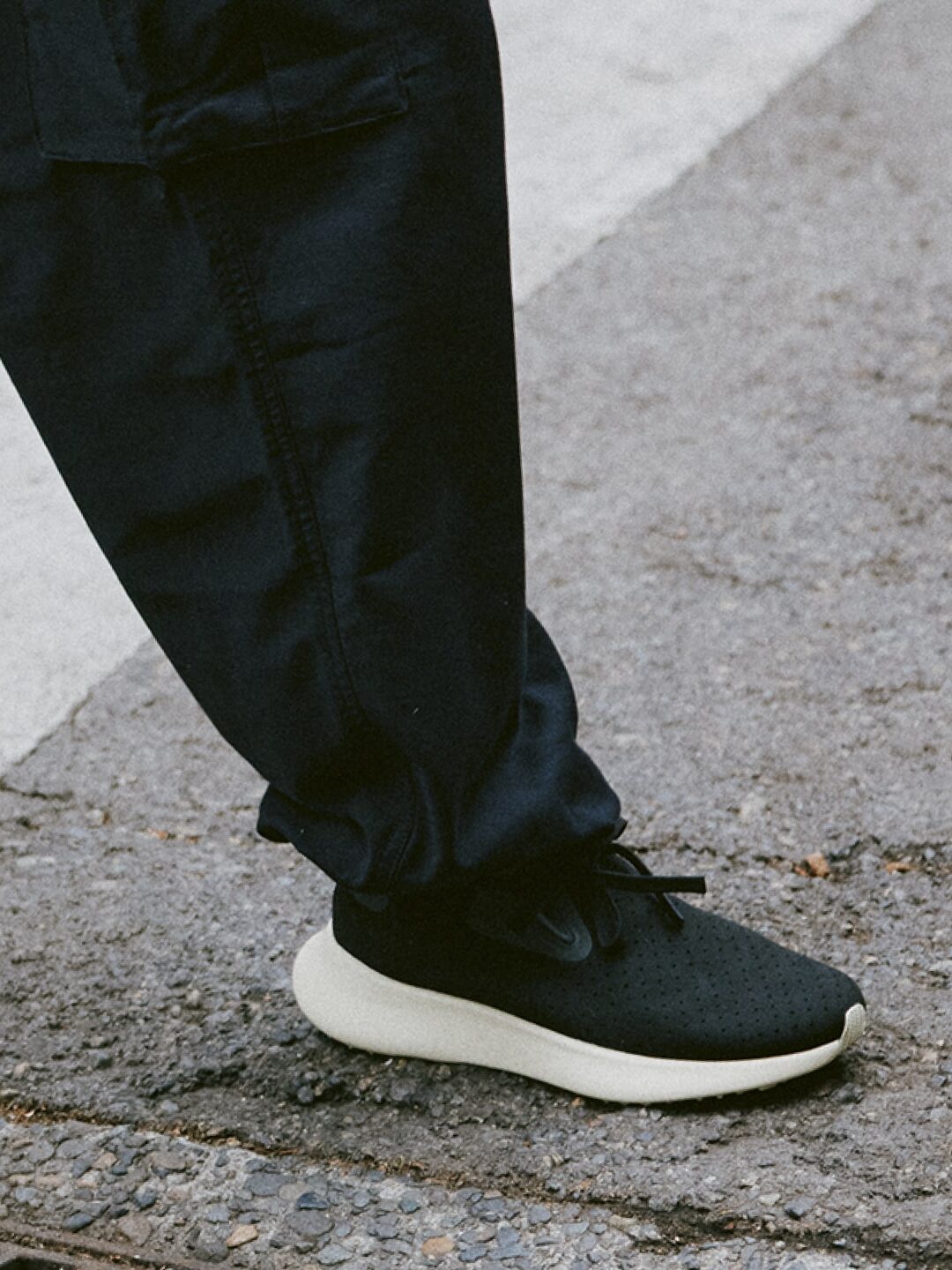 A model wearing black Apollo shoes from Native. 