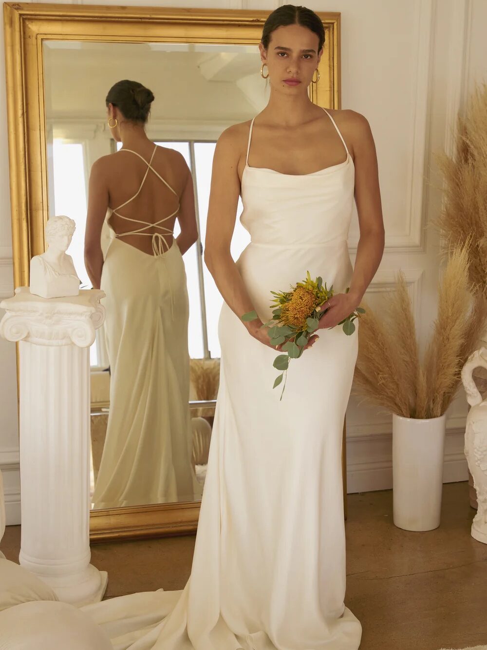 A model wearing a Whimsy + Row wedding dress.