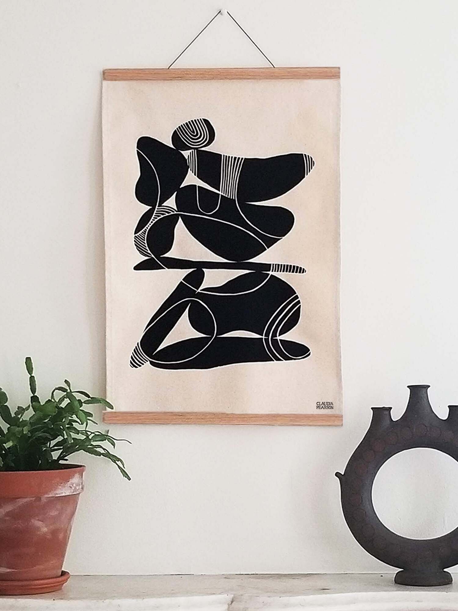 A wall hanging with an abstract design in black and white. 