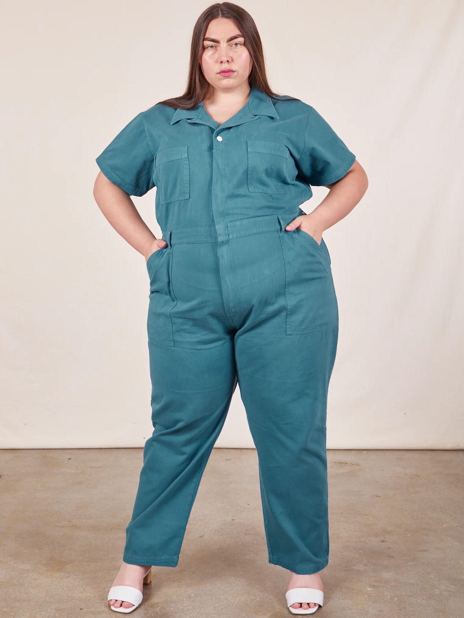 A model wearing a teal jumpsuit from Big Bud Press. 