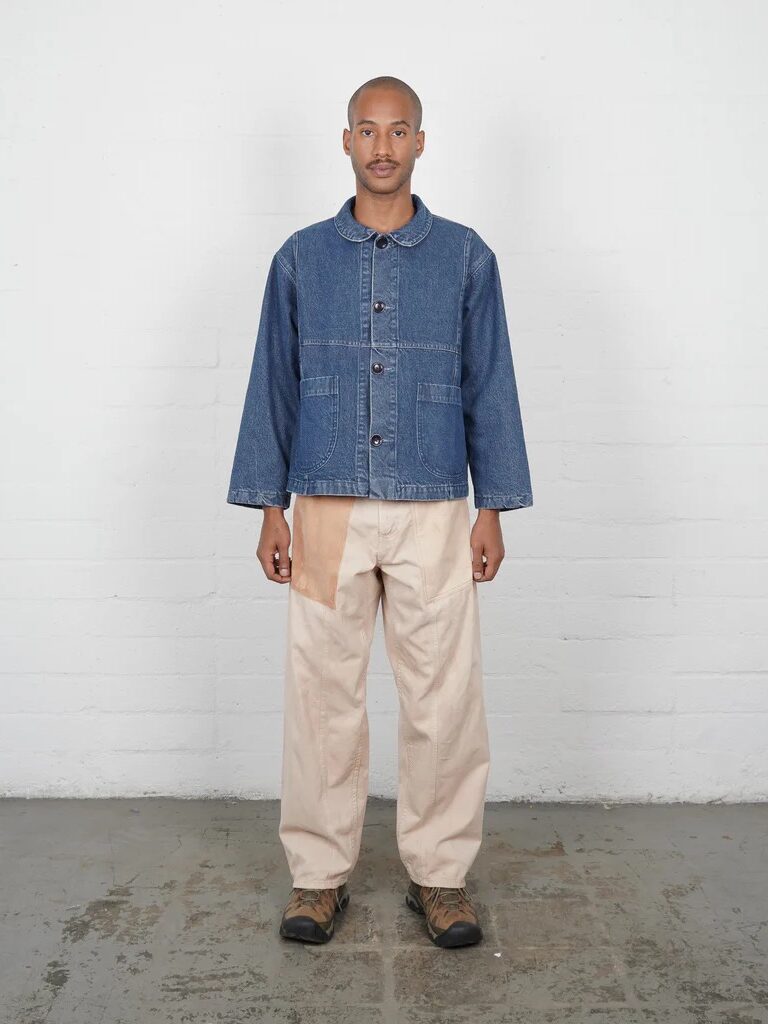 A model wearing a denim jacket and beige pants from Olderbrother. 