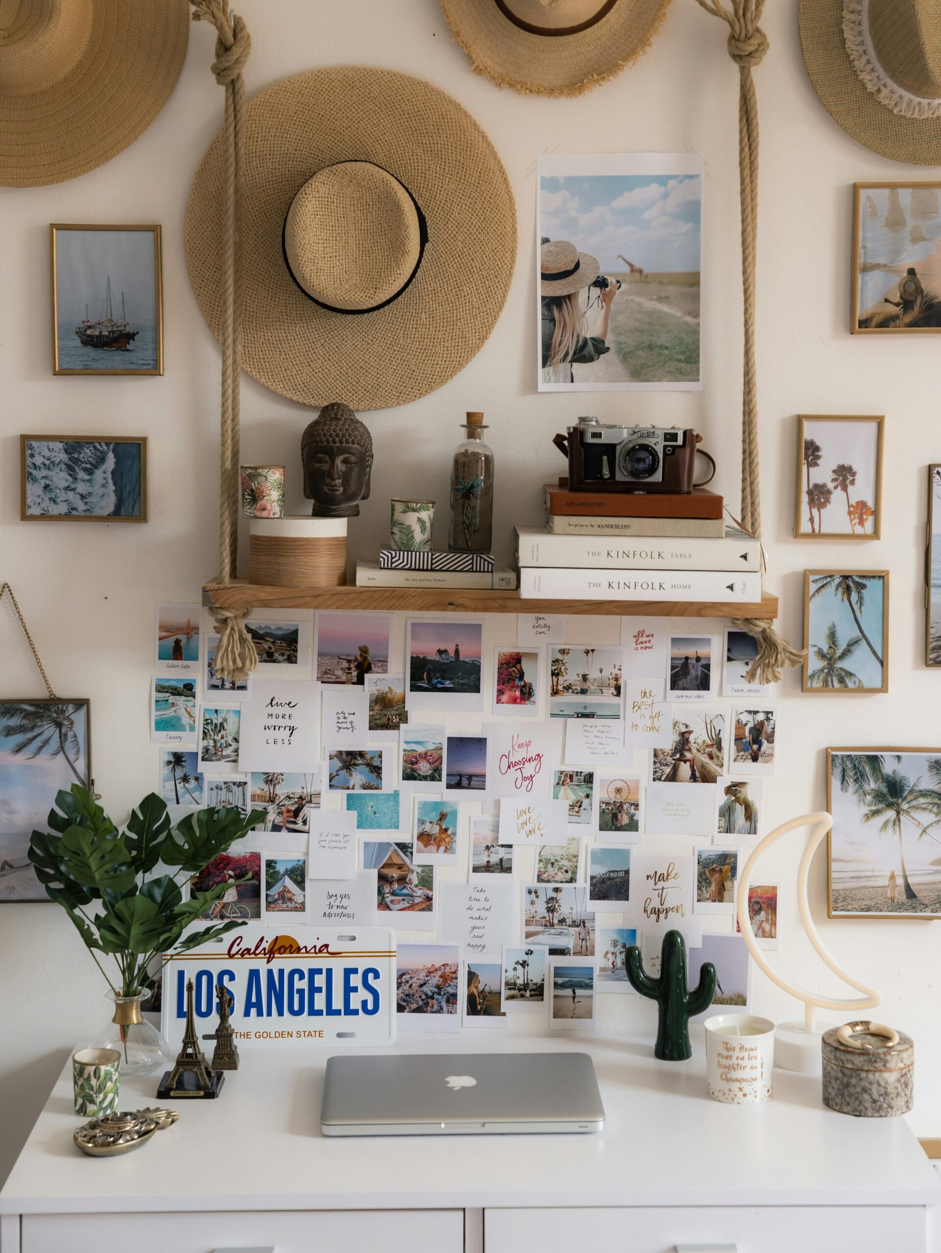 A vision board pasted on a wall behind a desk. 