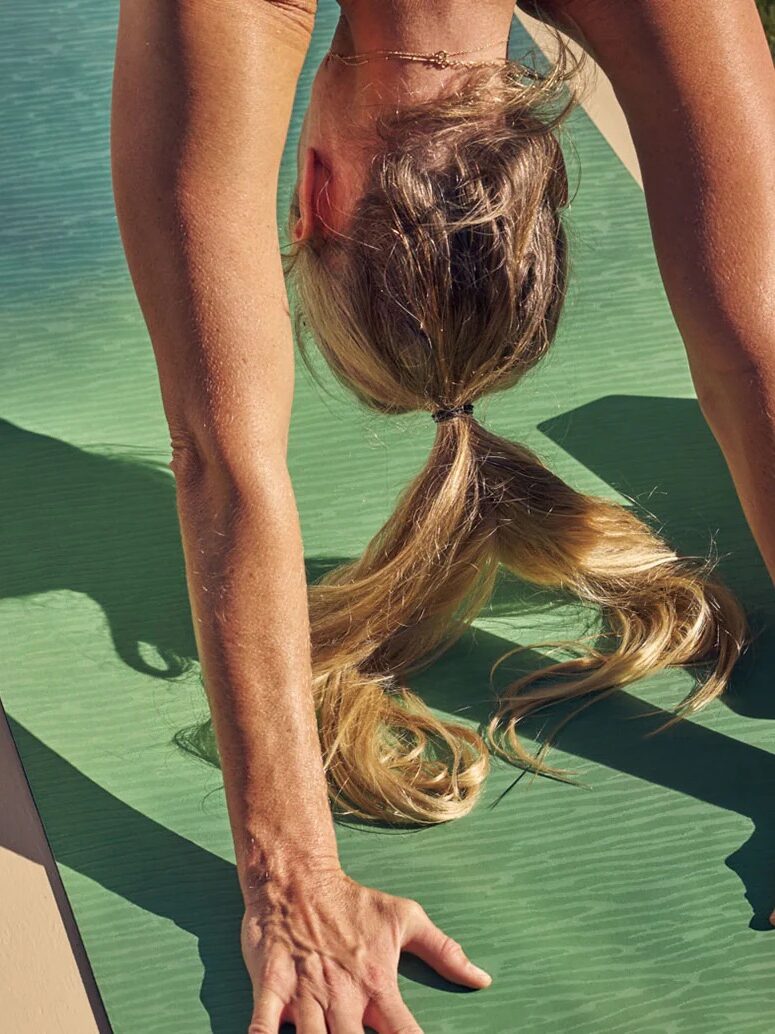 Close up of a person practicing yoga on a Manduka yoga mat. 