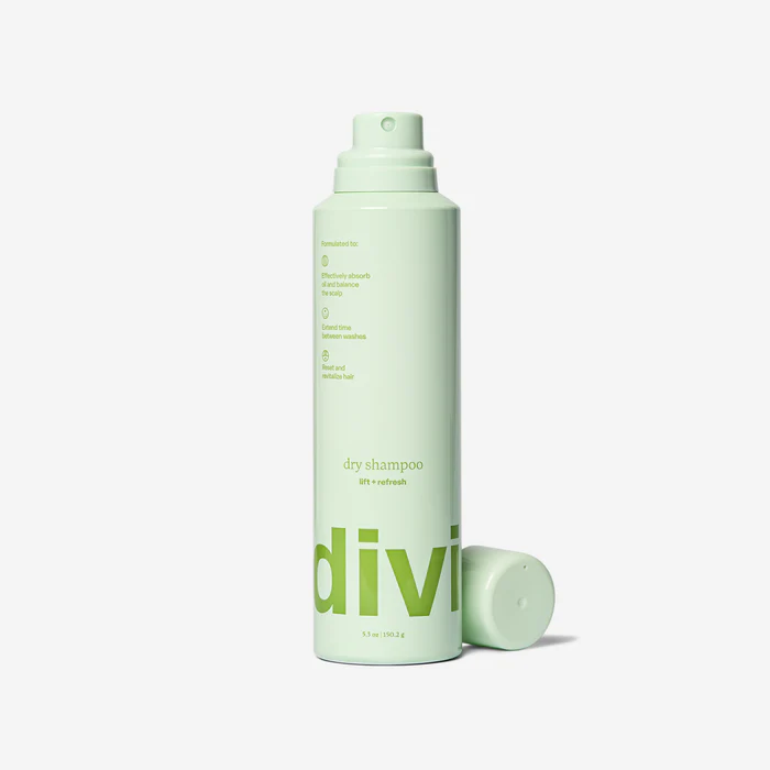 Green cylindrical bottle of Divi dry shampoo with a matching cap, featuring minimalist text design.