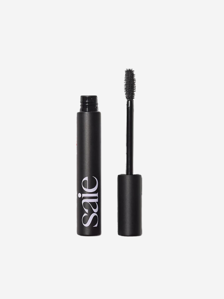 Black mascara tube and applicator with logo "saie" on the side, standing on a white background.