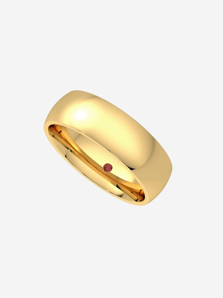 A simple gold ring with a smooth finish featuring a small red dot on the inner side.