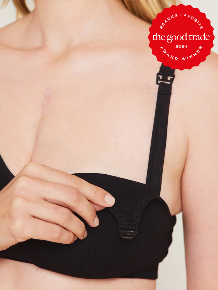 Close-up of a person adjusting the strap of a black bra. A red badge reads, "the good trade 2024 Reader Favorite Award Winner.