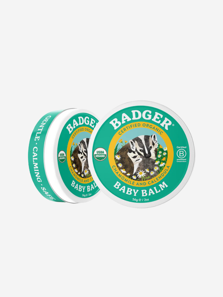 Two tins of Badger Baby Balm with green labels featuring a badger illustration, labeled as certified organic and containing chamomile and calendula.