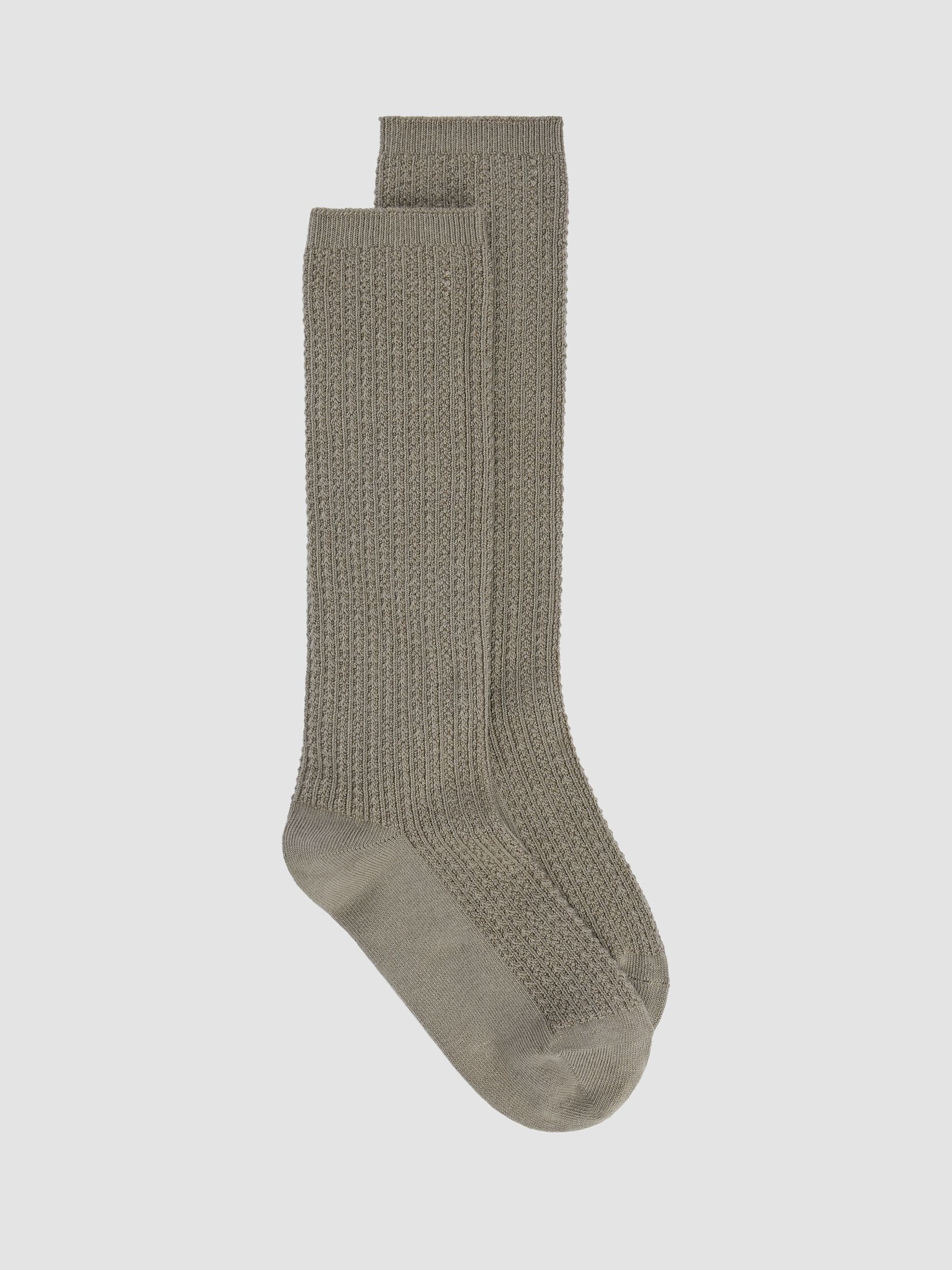 A pair of knitted, knee-high organic gray socks on a plain white background.