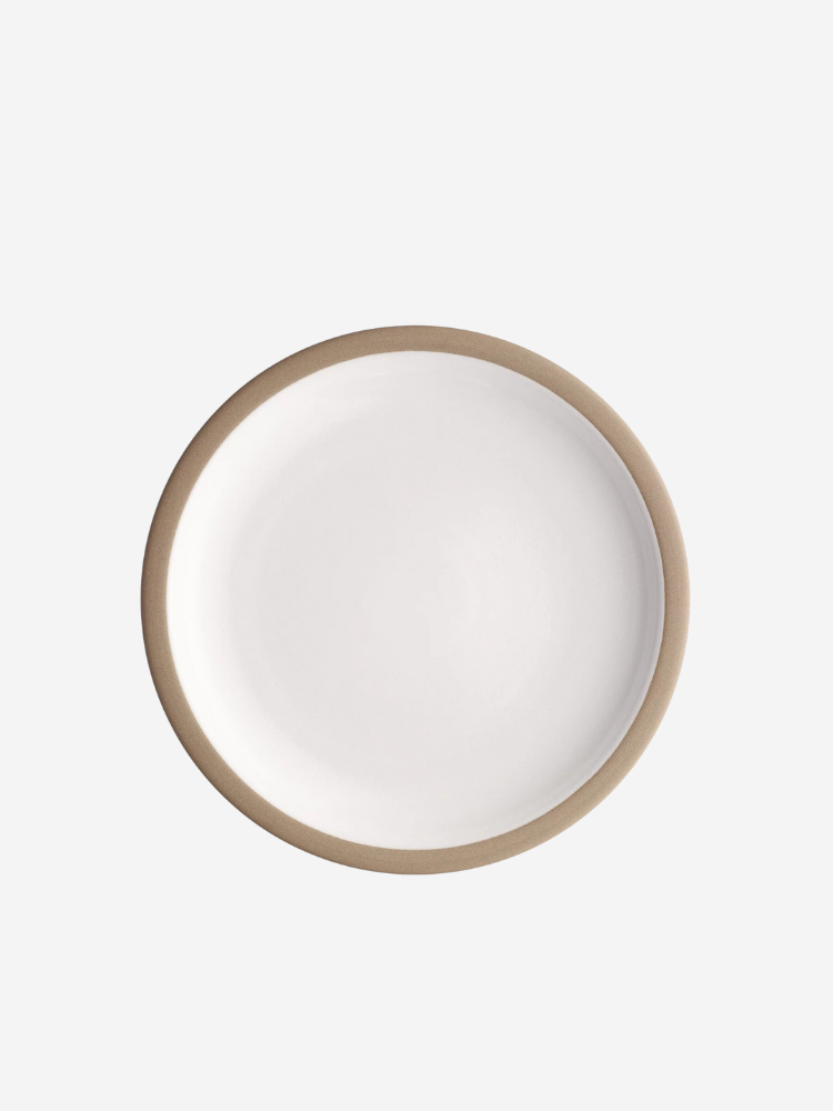 A round white plate with a brown rim on a plain background.