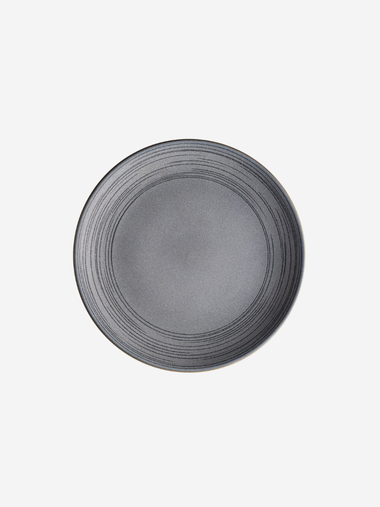 A round gray ceramic plate with a subtle circular pattern.