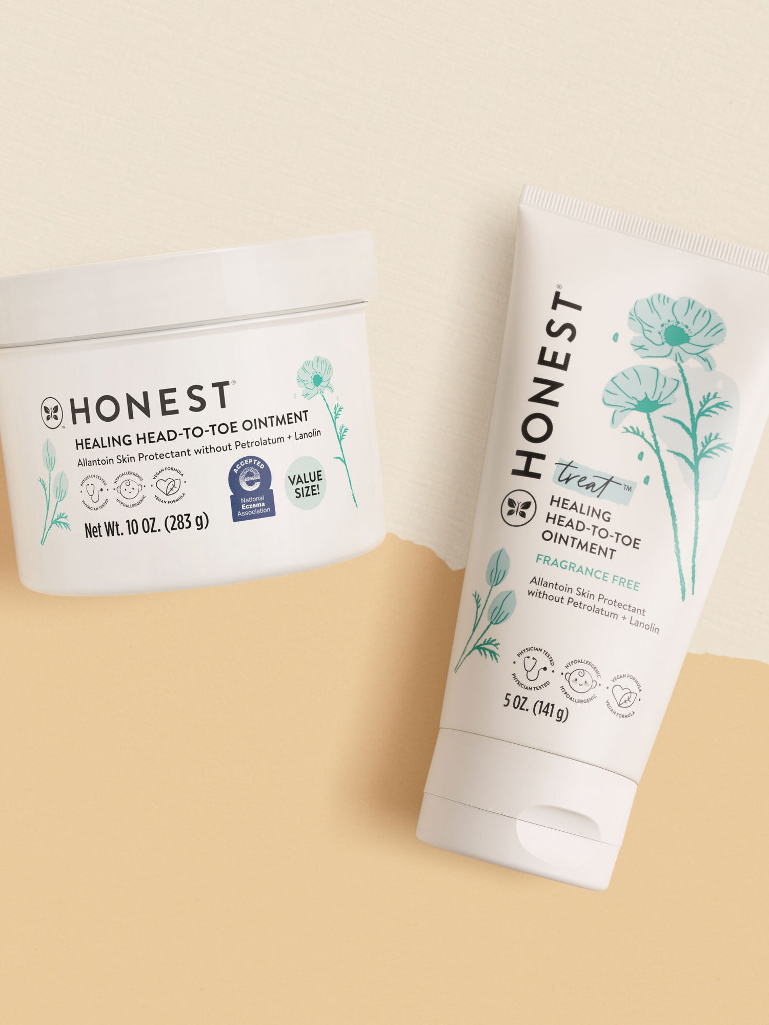 Two Honest brand ointment containers on a beige background; one is a white tub, and the other is a tube labeled "Healing Head-to-Toe Ointment.