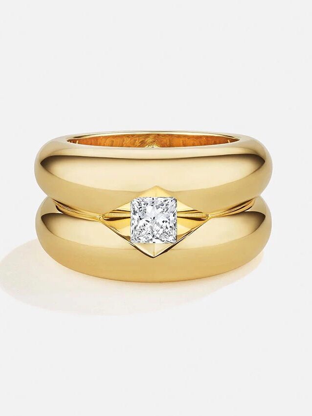 A gold ring with a square diamond set in the center.