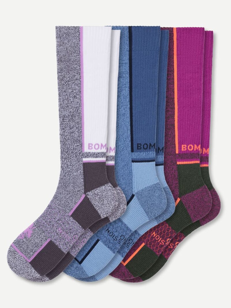 Four pairs of knee-high organic socks in various colors: gray, blue, and pink. Each pair features a vertical color accent and the brand name "BOM" near the top, offering both style and eco-friendly comfort.