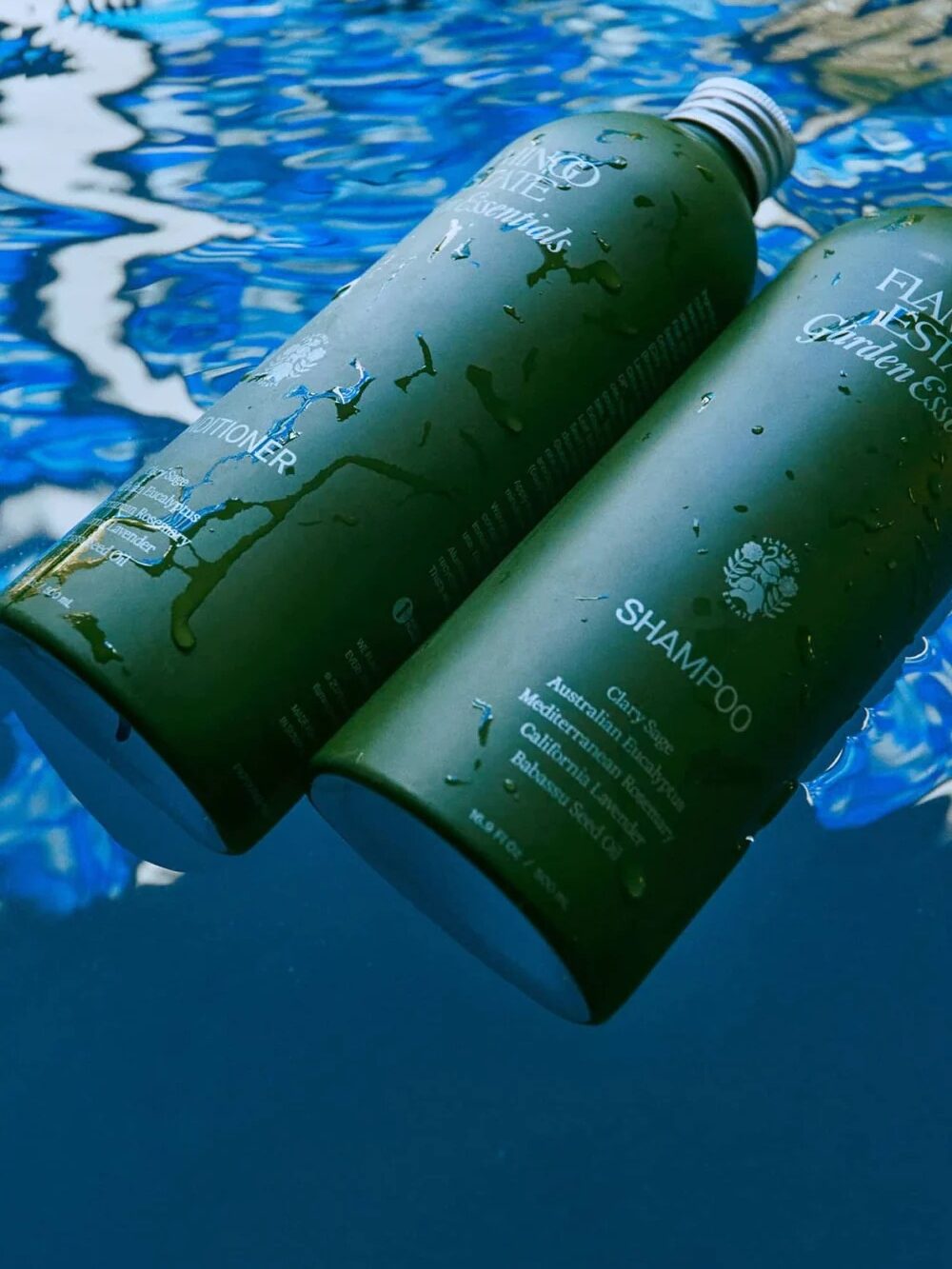 Two green bottles labeled "Shampoo" and "Conditioner" float on water with a blue and white pattern beneath.