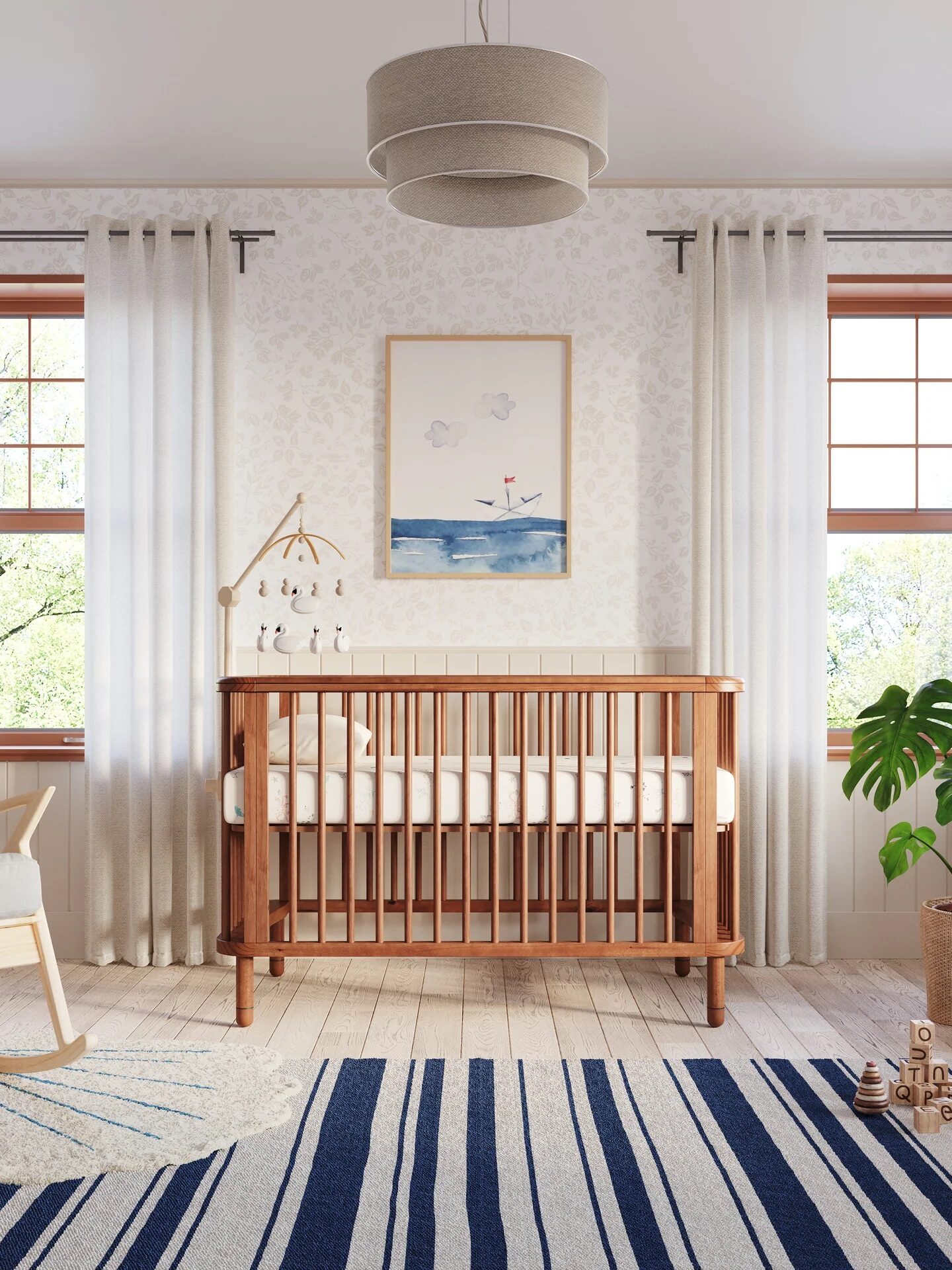 A cozy nursery features a wooden crib, striped rug, rocking chair, potted plant, and nautical-themed wall art. Soft natural light streams in through two large windows with white curtains.