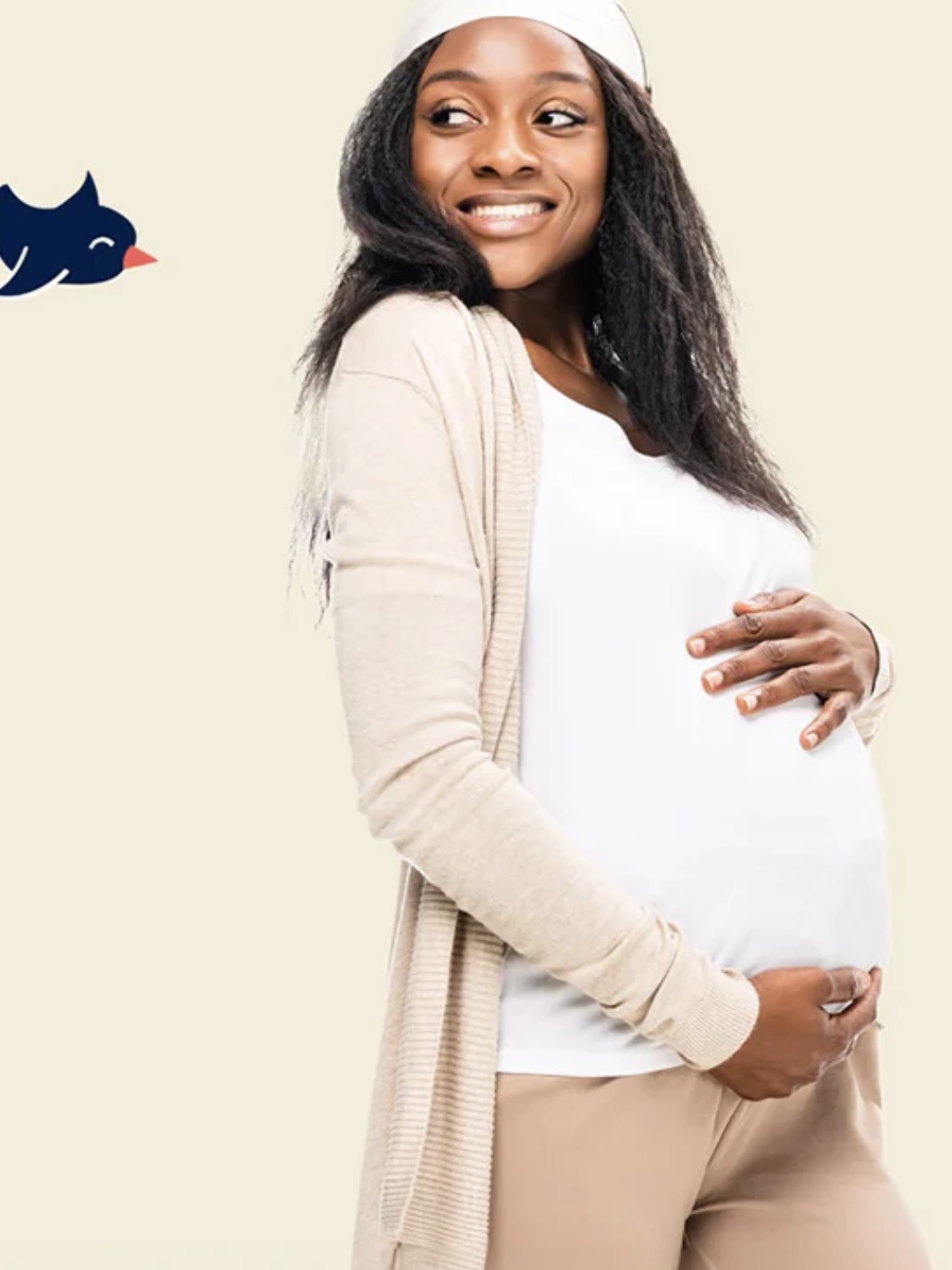 Pregnant woman smiling, holding her belly, wearing a white shirt and beige cardigan. Bird logo in the top left corner.