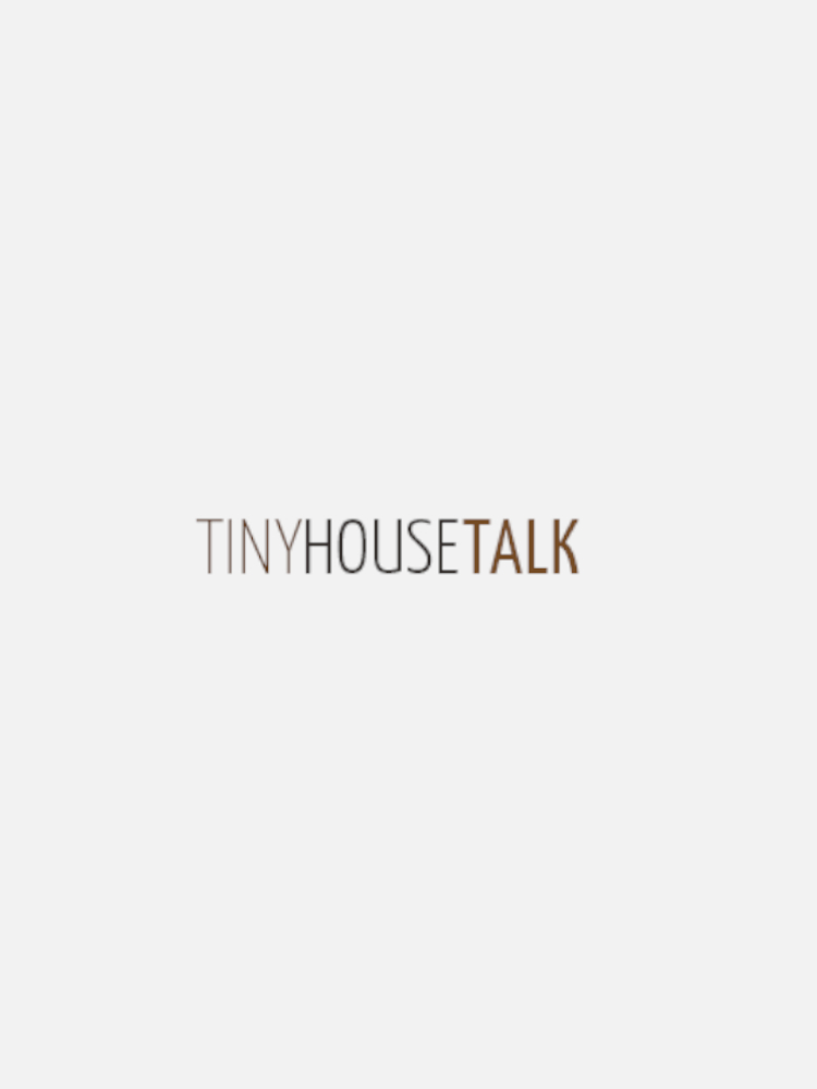 Logo with the words "Tiny House Talk" in thin, sans-serif font. The word "TINY" is in gray, "HOUSE" is in black, and "TALK" is in brown. The background is white.